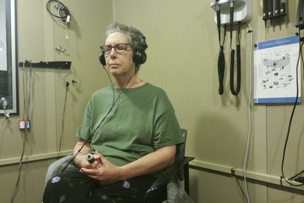 Hearing test in a soundproof room given using headphones and a signaling device the patient uses